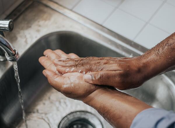 person washing hands before cooking